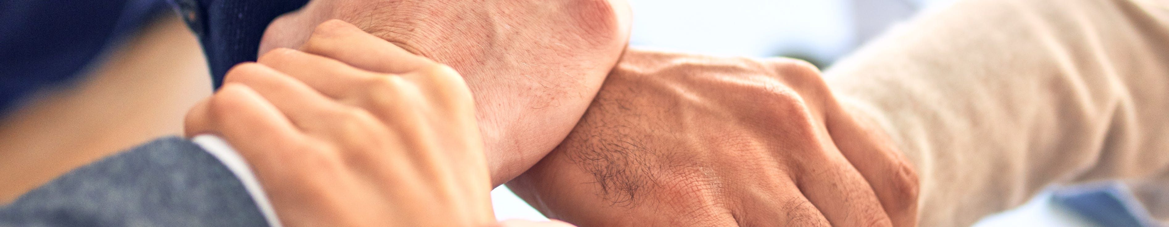 Doctors linking arms and working together